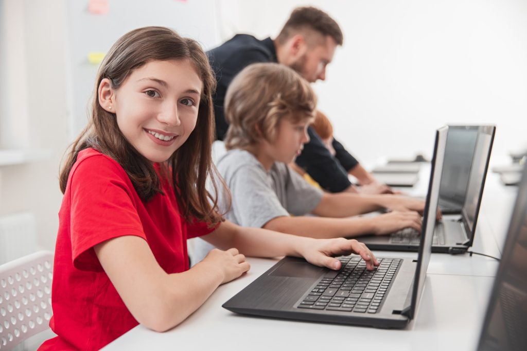 Smart kids studying programming in classroom